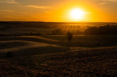 Kırsal alanlarda gün batımı ve altın güneş ışığı. Kırsalda hava karardı..