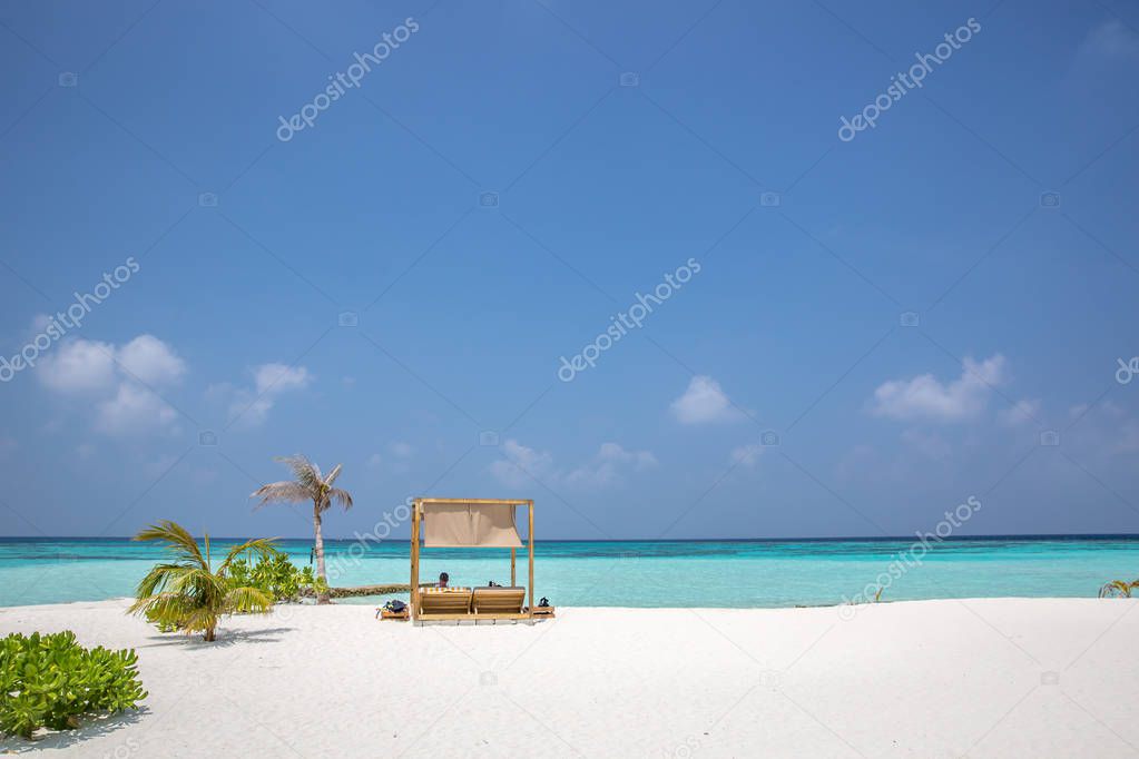 Amazing beach, yellow beach umbrella, blue sky, concept of paradise, perfect gateway vacation.