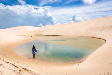 Lonaly woman at amazing landscape of Lencois Maranhenses at north of Brazil clipart