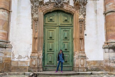 Ouro Preto'daki, Minas Gerais - 2 Kasım 2018 - genç kadın önünde ünlü Kilisesi, Saint Francis Assisi, Ouro Preto'daki, Brezilya'da bir bulutlu gökyüzü gün Rokoko Katolik kilise