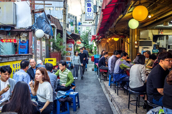 Seoul, South Korea - Sept 10th 2018 - Big group of people having dinner in a open and simple local restaurant in Seoul in South Korea