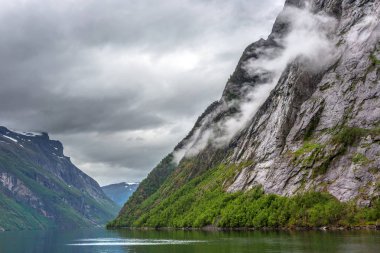 The fjords of Norway in a cloudy, overcast day clipart