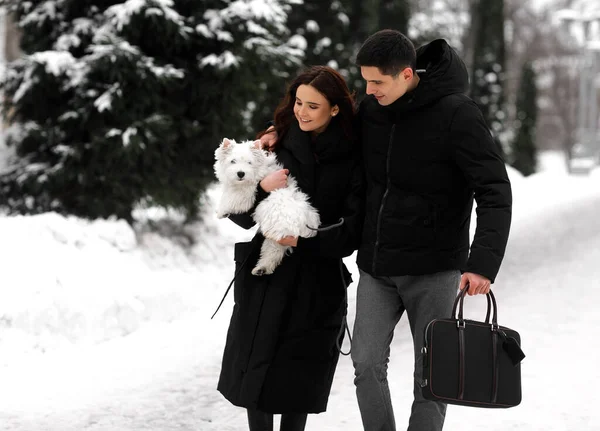 Couple walking with dog outdoor
