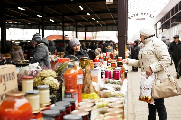 Food market stall with big choice of products, drinks, conservation, spices, sauces, honey