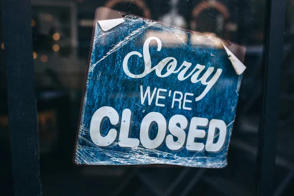 Inscription on a door: Sorry we are closed. Conceptual photo or table on door with information of work. Announcement or work schedule — Stock Photo, Image