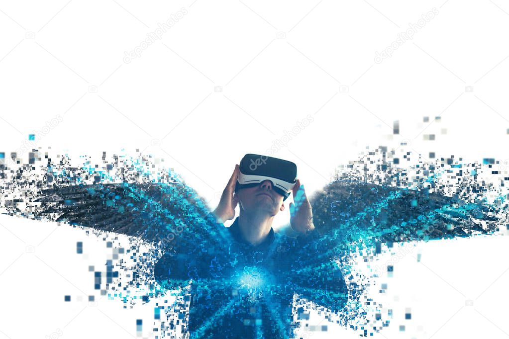 The person in glasses of a virtual reality with wings is scattered on pixels. The concept of new technologies and technologies of the future.VR glasses