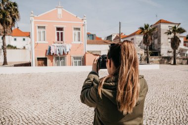 Bir sokak fotoğrafçı ya da genç bir kadın Lizbon Portekiz otantik evlerde çekiyor. Bir profesyonel fotoğrafçı ya da bellek için fotoğraf çekmek turist
