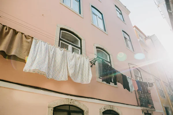 Hiteles fotózás. Ruhák száraz, a homlokzaton, egy bérház Lisszabonban, Portugáliában. A portugál jellemző tulajdonsága mindenhol lógni ruházat, textília, száraz. — Stock Fotó