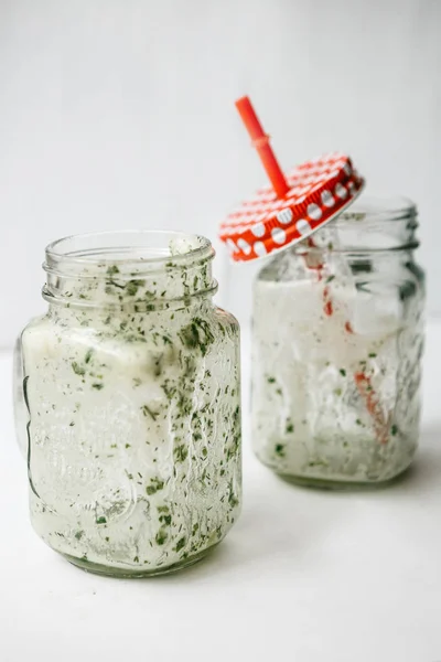 Empty jars with a green cocktail. Conceptual photography. Ending a meal or a veggie party or vacation