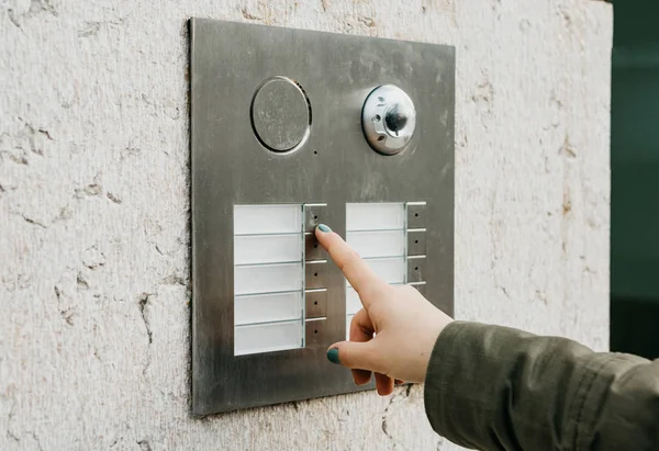 Kadın el baskıyı doorphone düğmesini kapatın. Kız interkom arıyor