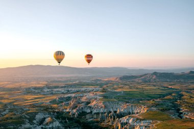 Şafakta sabah veya akşam gün batımında gökyüzünde uçan balonlar