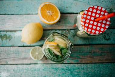 Ev yapımı narenciye limonata veya meyve suyu veya bir ahşap yüzeyde bir kavanoza mojito. Narenciye içki.