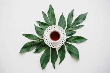 Yararlı güzel kokulu lezzetli bitkisel veya siyah çay güzel koydu yaprakları yanında beyaz bir yüzeye