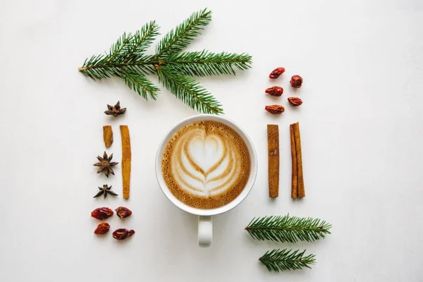 Чашка вкусного свежего кофе капучино на белой поверхности, оформленной в рождественском стиле — стоковое фото