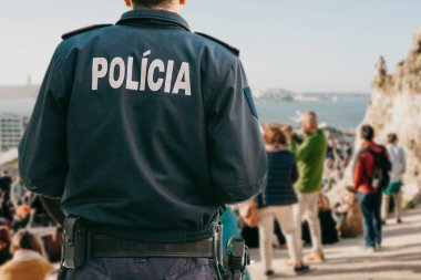 View from the back of a Portuguese policeman guards public order clipart