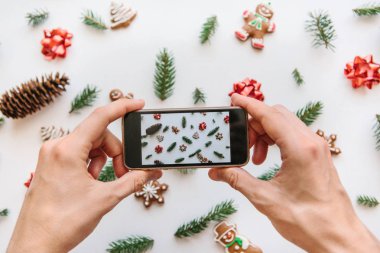 Bir adam bir Noel ve yeni yıl arka plan cep telefonundan fotoğraf çekimi.