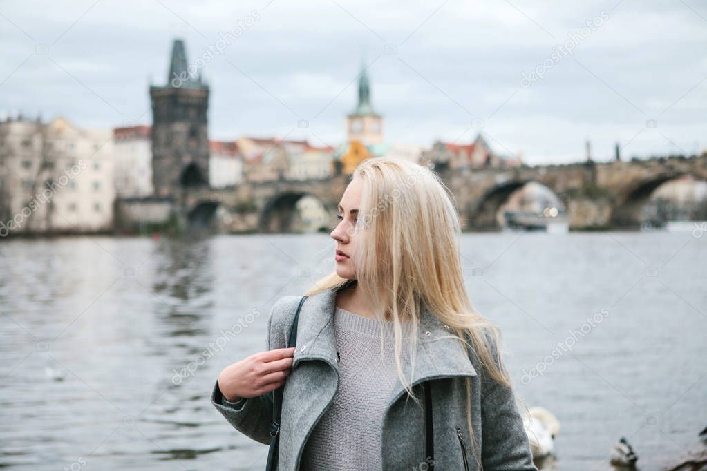 Fashionable blonde with long hair in a coat.
