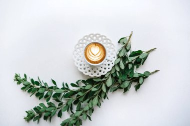 Taze kokulu kapuçino bitki dalları yanında kahve bir fincan.