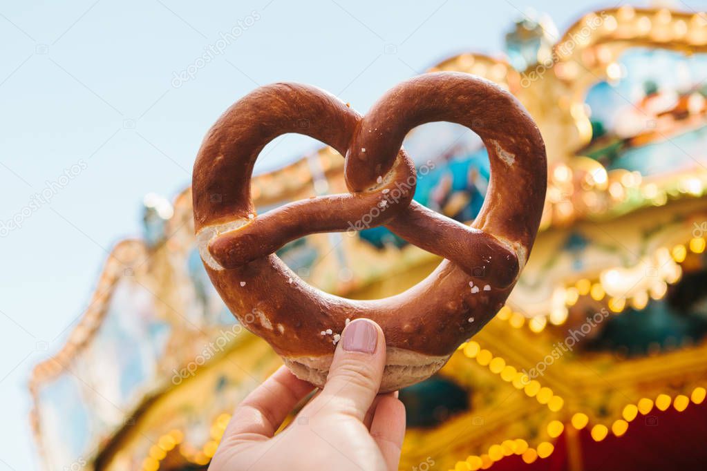 The girl is holding a traditional German pretzel.