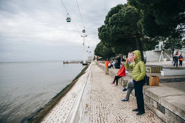 Portugal, Lisbon 30 april 2018: embankment with public improvement and funicular or ropeway. Pedestrian street and people or tourists have rest ashore. — Stock Photo, Image