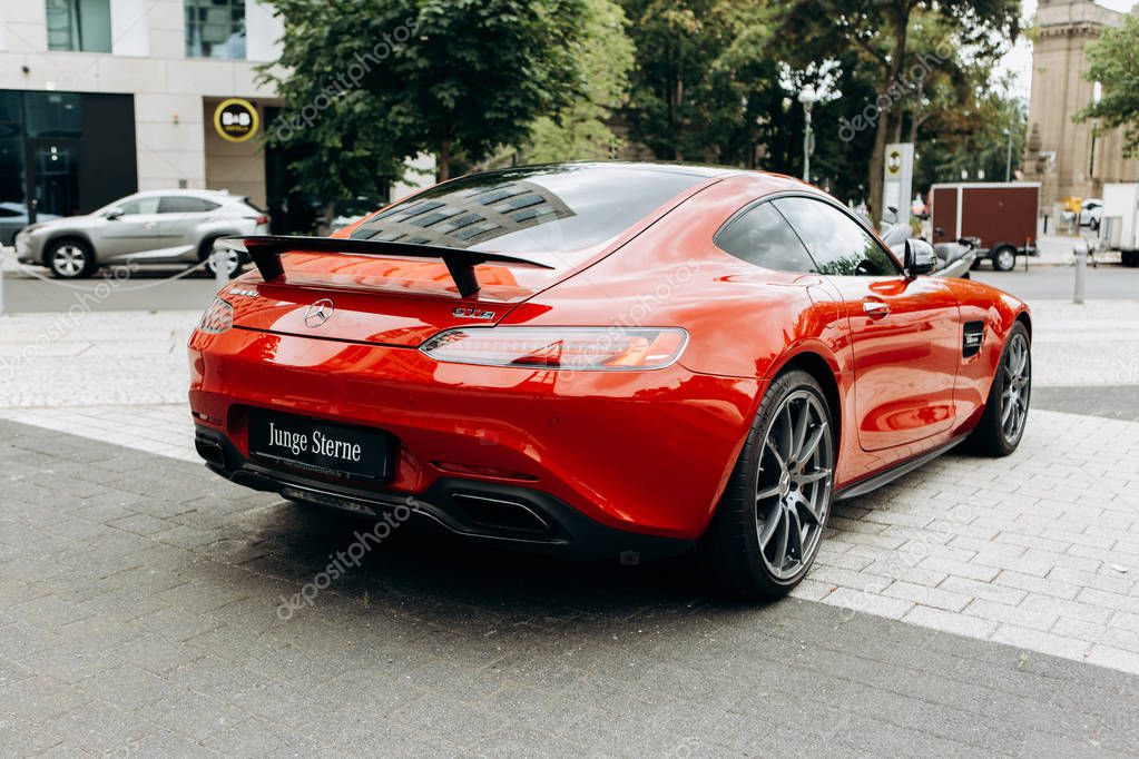 Berlin, August 29, 2018: A close-up of the new red Mercedes-Benz AMG GT is parked next to the official Mercedes-Benz dealership in Berlin. The inscription in German is translated as young stars.