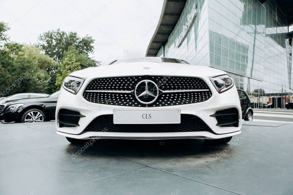 Berlin, August 29, 2018: A close-up of the new white Mercedes-Benz CLS is parked next to the official Mercedes-Benz dealership in Berlin.