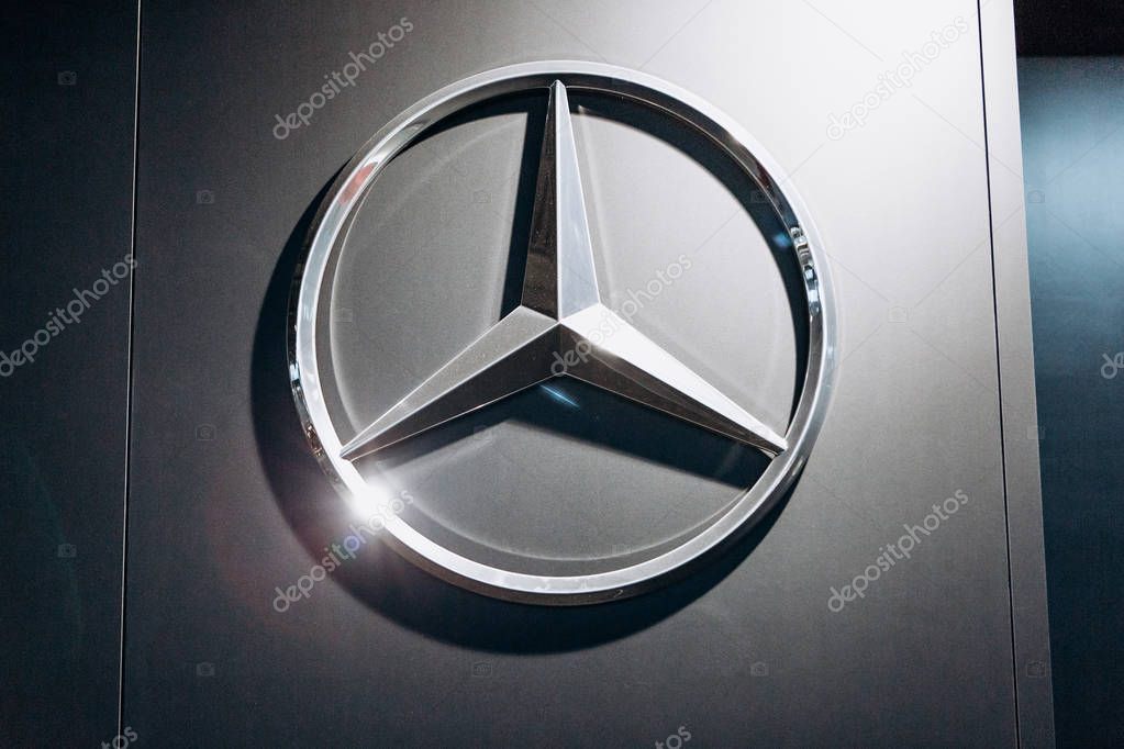 Berlin, August 29, 2018: A close-up photograph of the Mercedes-Benz sign on the stand in the official dealer firm in Berlin. The world-famous German car manufacturing company.