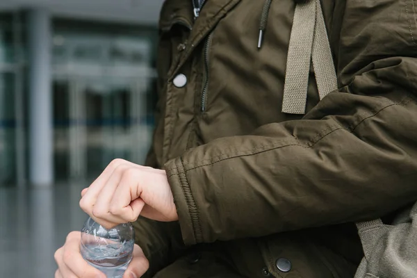 Le voyageur ouvre une bouteille d'eau à boire . — Photo