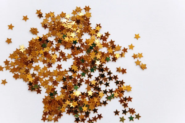 Festive background of golden confetti stars — Stock Photo, Image