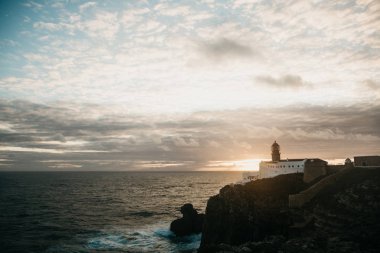 Deniz feneri ve kayalıklarla Portekiz Cape St. Vincent, gün batımında görünümü.