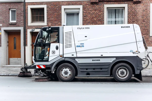 A special truck or street cleaning vehicle rides along the road and cleans the street from dirt and dust. — Stock Photo, Image