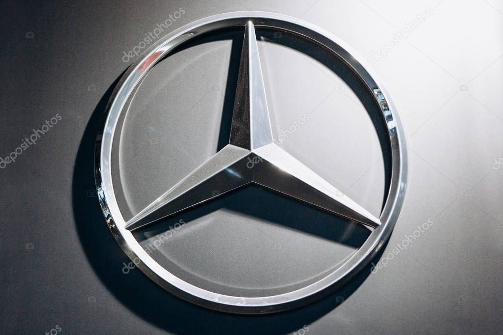Berlin, August 29, 2018: A close-up photograph of the Mercedes-Benz sign on the stand in the official dealer firm in Berlin. The world-famous German car manufacturing company.