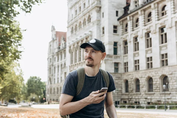 Турист или мальчик с рюкзаком пользуется мобильным телефоном — стоковое фото