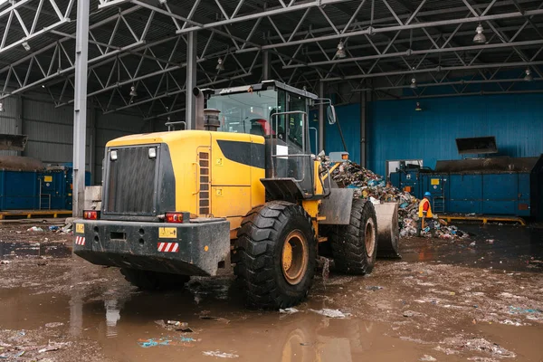 Special machinery or bulldozer work on the site of waste unloading at the plant for waste disposal. — Stock Photo, Image