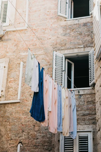 Clothes dry on the facade of an apartment building