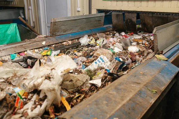 Waste sorting plant. Conveyor on which waste is moving.