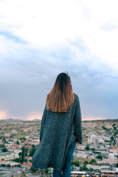 A view from the back of a girl admires the beautiful view.