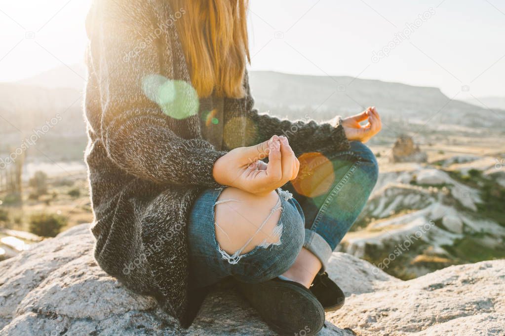 A girl practices yoga or meditation