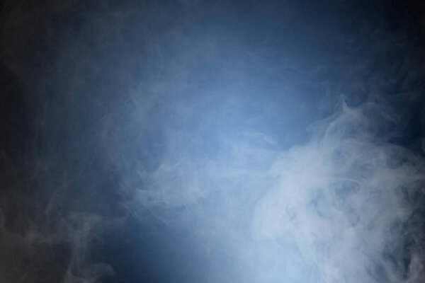 Smoke or fog over blue black background