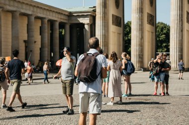 Turist turistik yerleri Brandenburg Kapısı yanındaki meydanda güneşli bir günde hayranım. Berlin.
