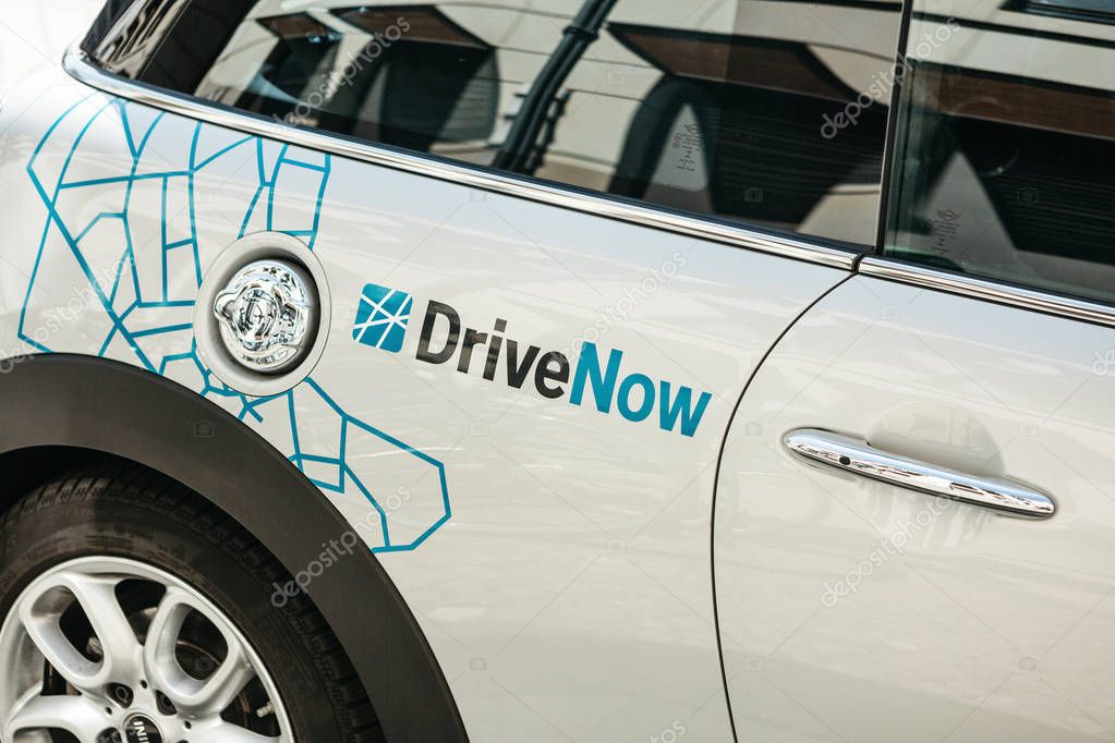 Germany, Berlin, September 05, 2018: Close-up on a company sign on a BMW electric car for the rental from a company called DriveNow. Car rental takes place through a mobile application.