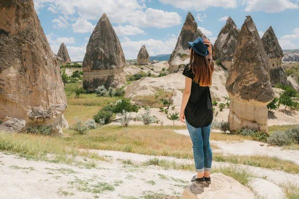 Kobieta stoi obok pięknych skał i podziwia krajobraz w Kapadocji w Turcji. Krajobraz Kapadocji. — Zdjęcie stockowe