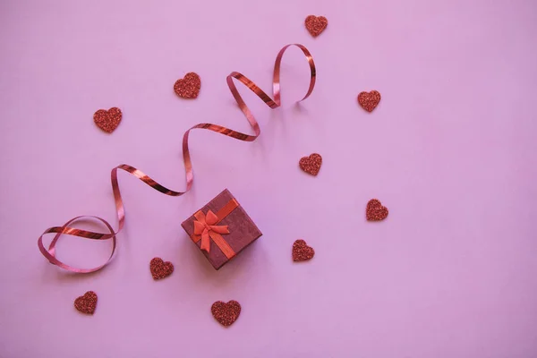 Red box with hearts next to it. Concept for Valentines Day — Stock Photo, Image