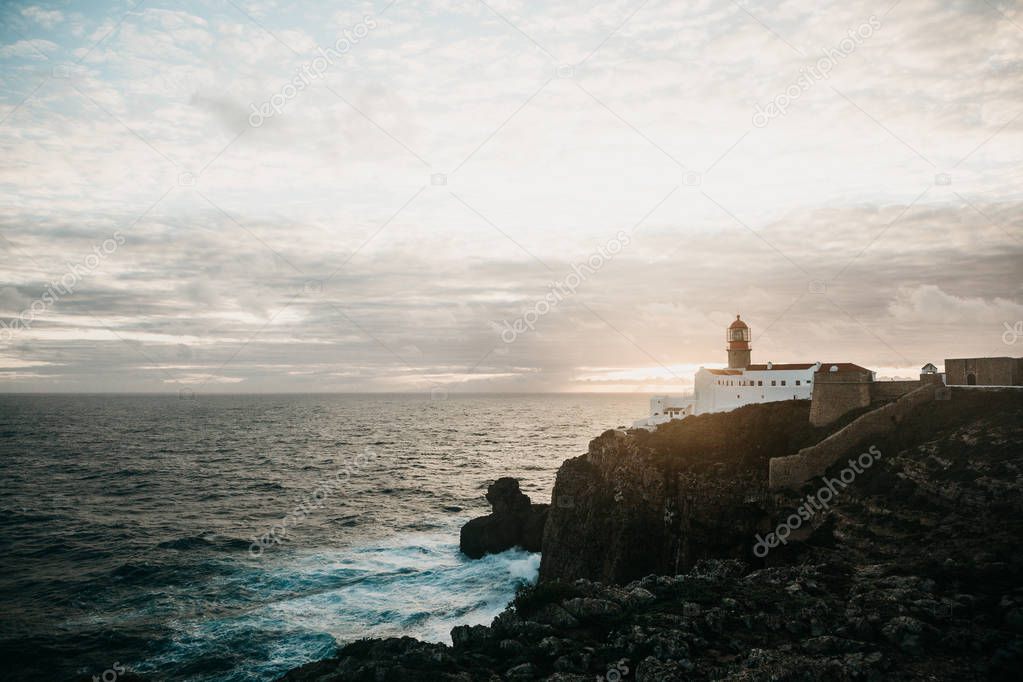 View of the lighthouse and cliffs at Cape St. Vincent in Portugal at sunset.