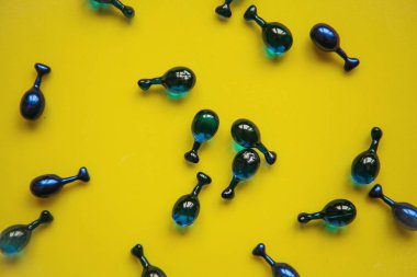 Dolgu maddeleri veya kapsül hyaluronik asit üzerinde sarı bir arka plan ile. Cilt Bakımı ve yüz sağlık