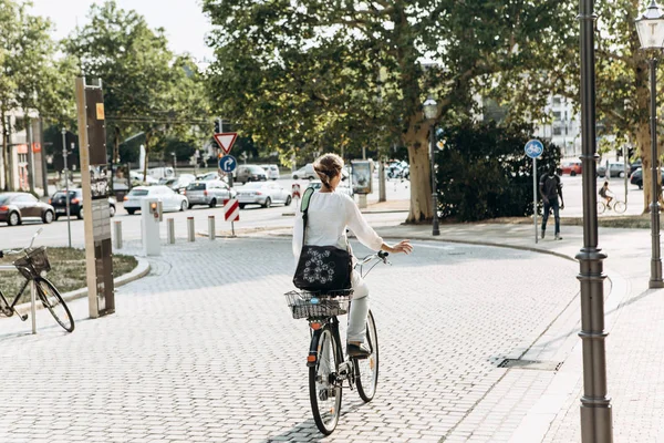 Chica o mujer montando en bicicleta por la calle en Leipzig en Alemania . — Foto de Stock