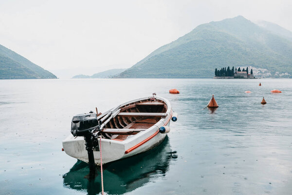 Lonely fishing boat on the water. Relaxation and tranquility.