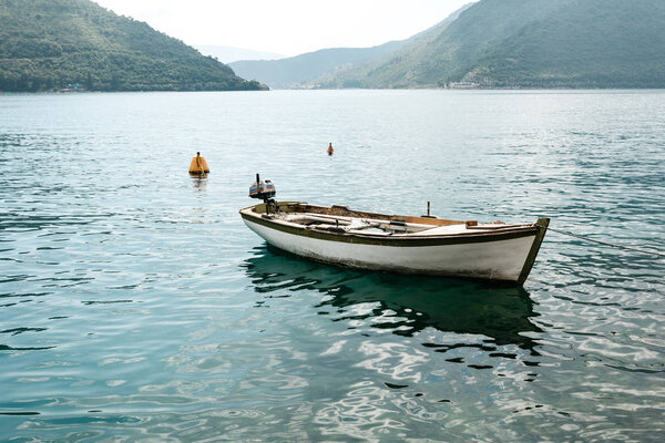 Lonely fishing boat on the water. Relaxation and tranquility.