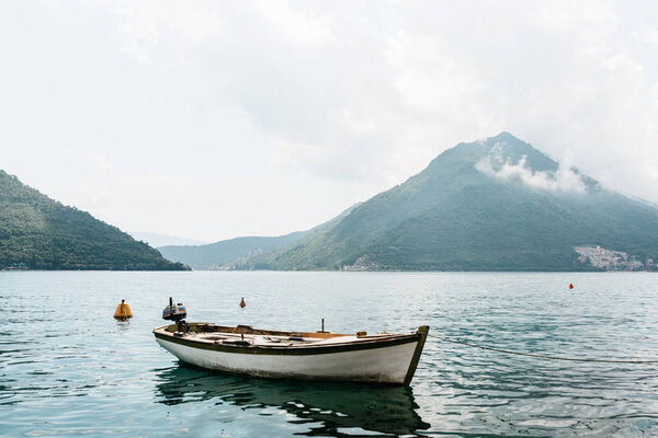 Lonely fishing boat on the water. Relaxation and tranquility.