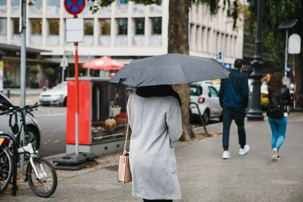 A woman with an umbrella.